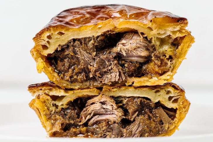 juicy meat pie cut in half and stacked